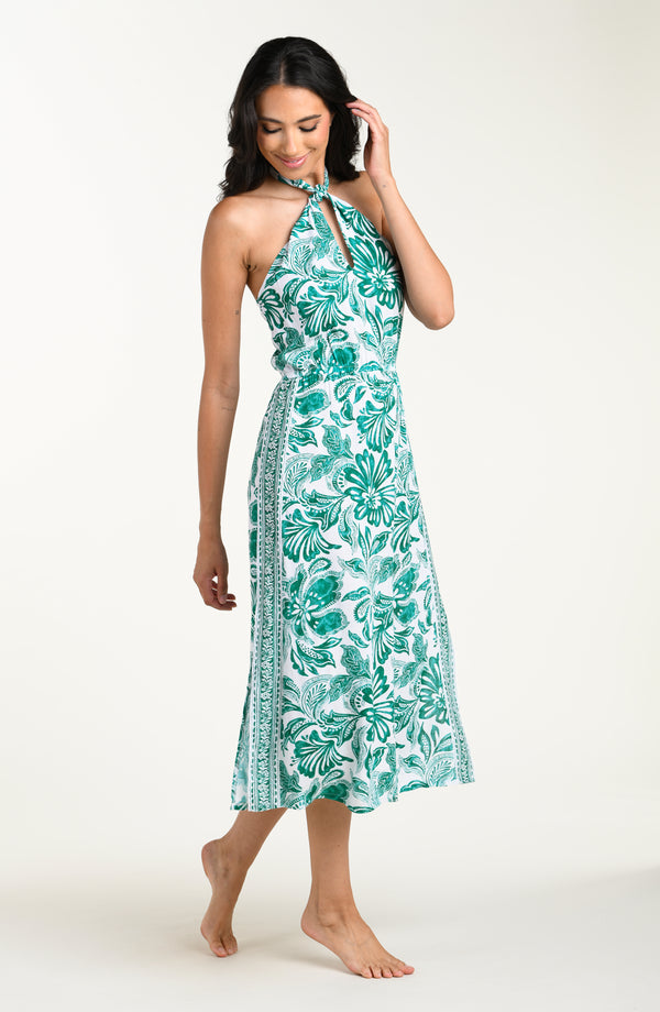 Woman wearing a green floral dress on a white background