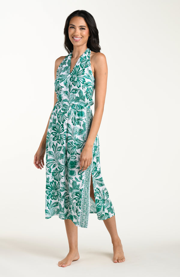 Woman wearing a green floral dress on a white background