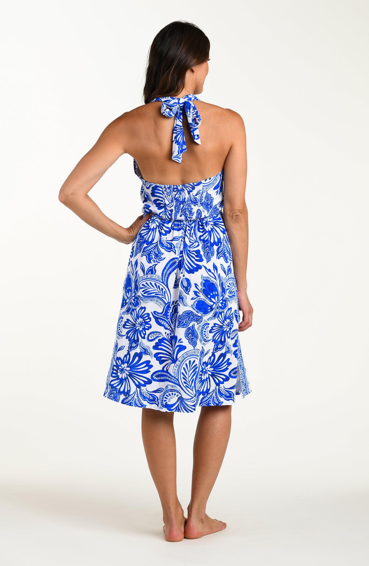 
                  
                    Woman wearing a blue floral dress on a white background
                  
                