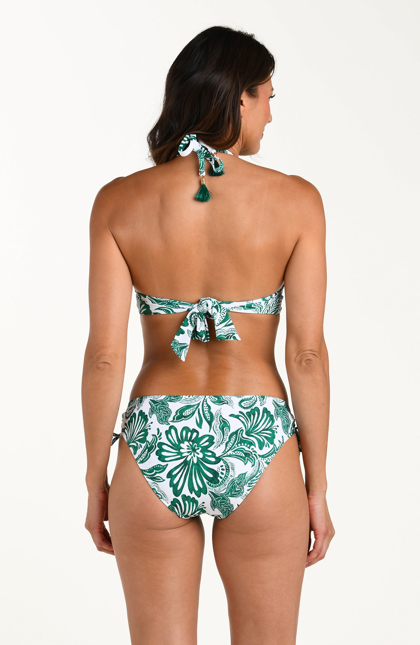 
                  
                    Woman wearing a green and white patterned bikini top and matching bottom on a white background
                  
                