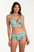 Woman wearing a green and white patterned bikini top and matching bottom on a white background