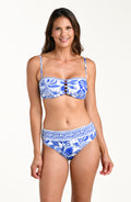 Woman wearing a blue and white patterned bikini top and matching bottom on a white background
