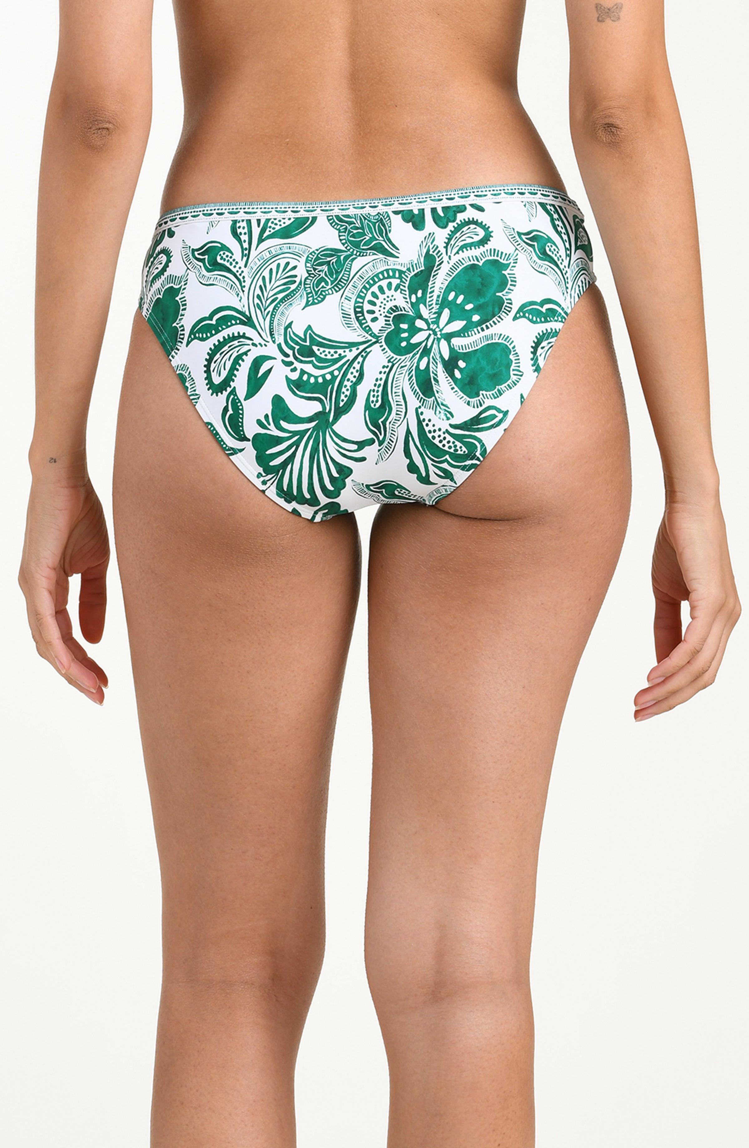 Green and white floral-patterned bikini bottom on a white background