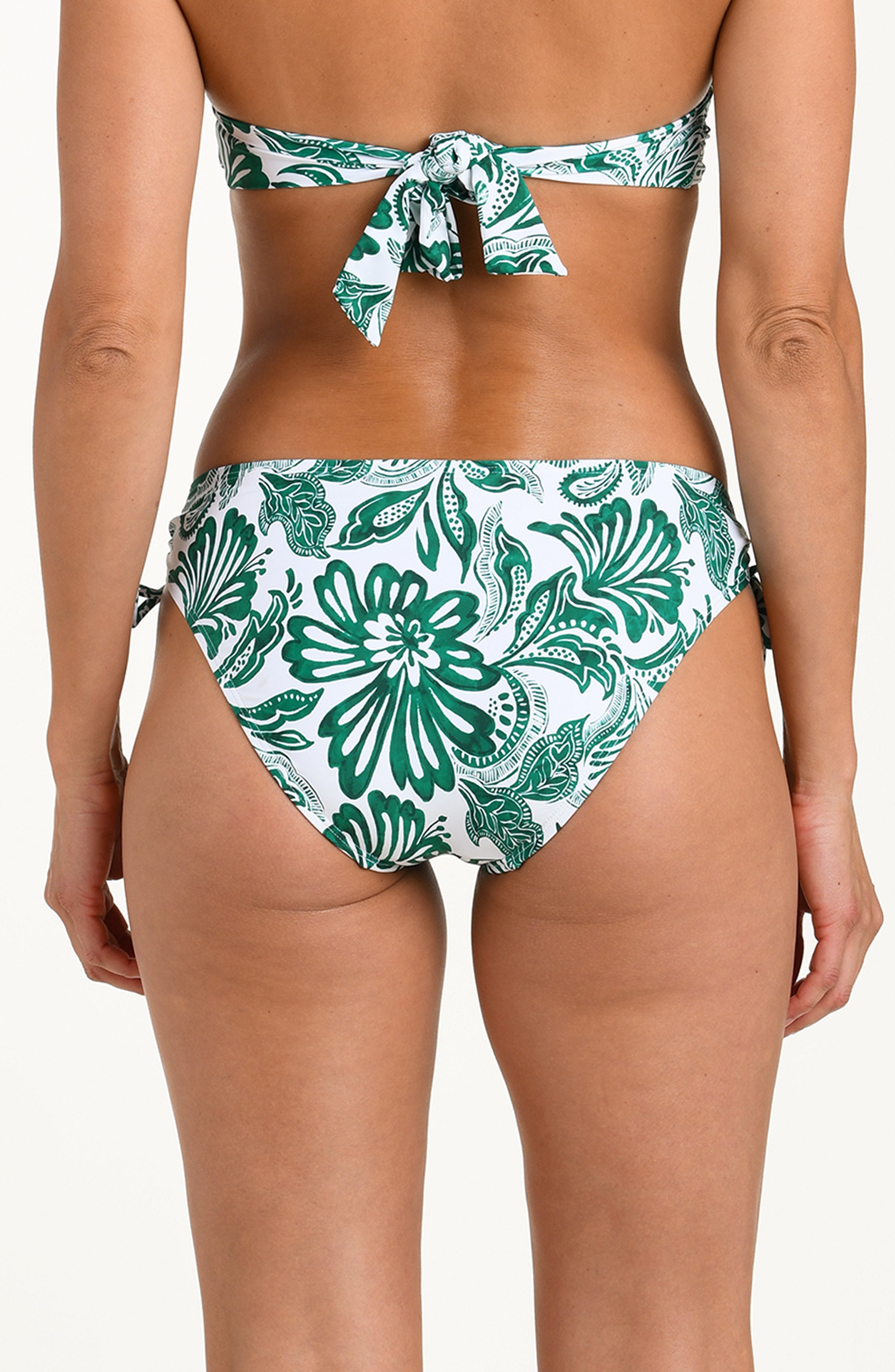 Green and white patterned bikini bottom with tassels on a white background