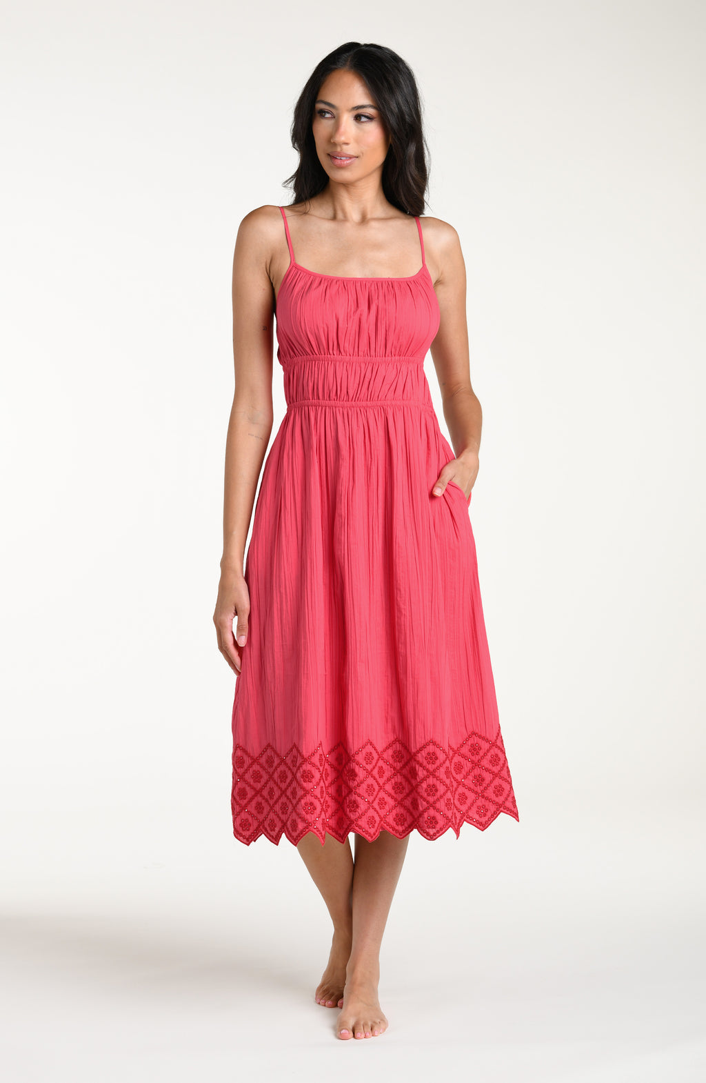 Woman wearing a guava colored midi cover up dress against a white background