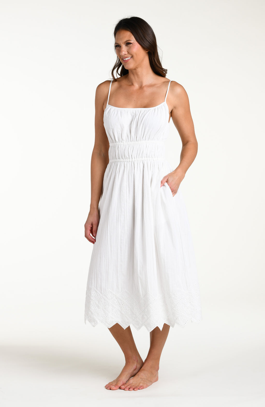 Woman wearing a white midi cover up dress against a white background
