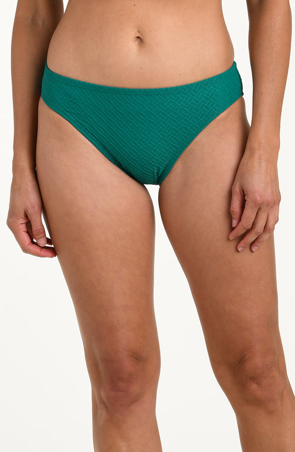 Teal bikini bottom worn by a person on a white background
