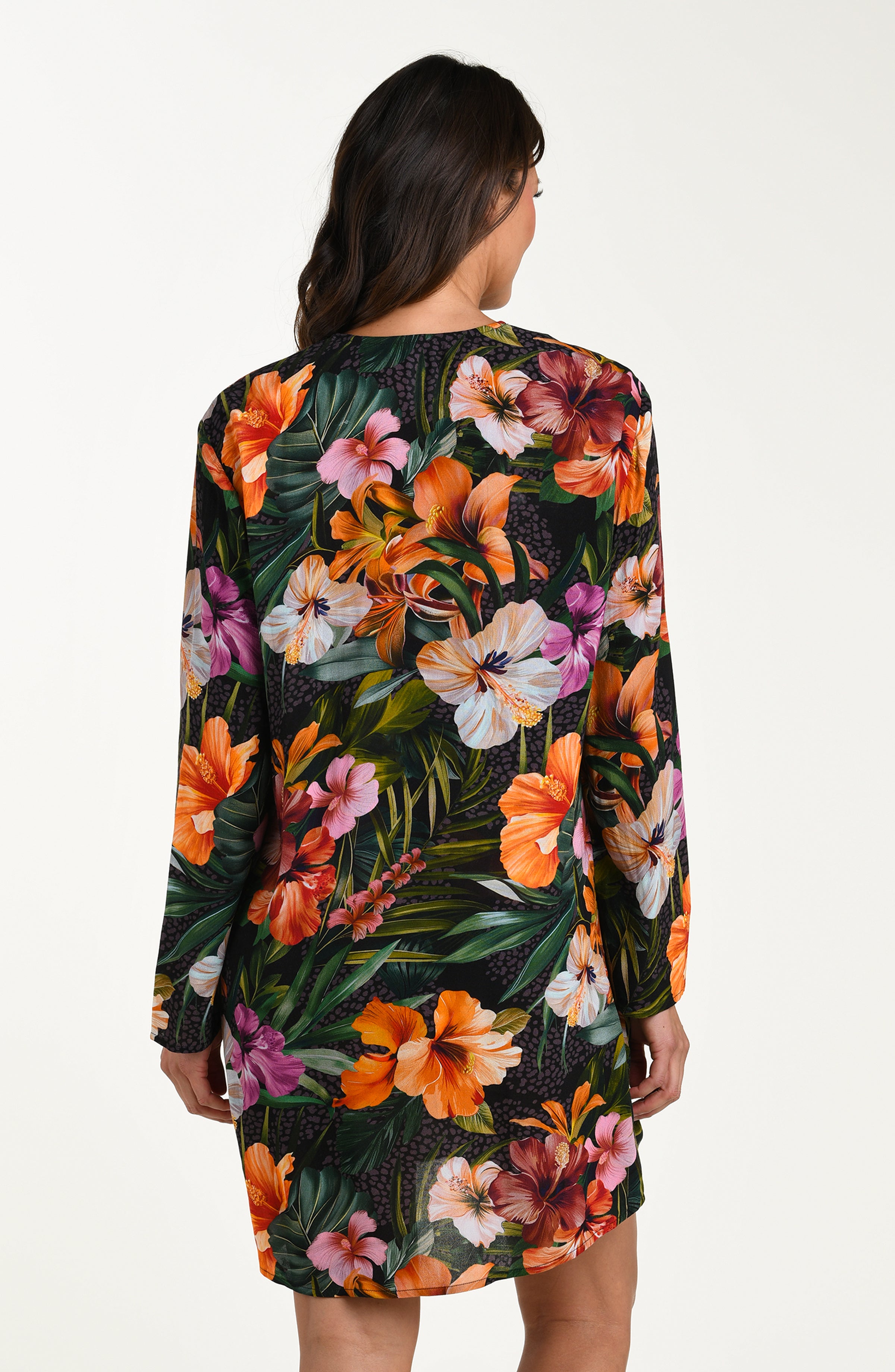 Back image of model wearing a multicolored tropical printed tunic cover-up featuring a loose, breezy fit with long sleeves and a lace-up neckline for effortless comfort and style.