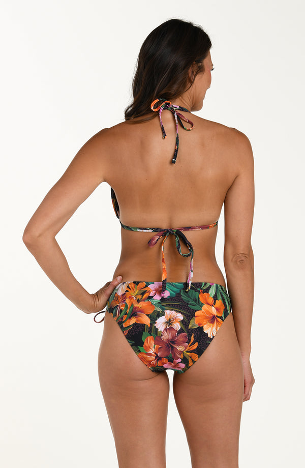 Back image of model wearing a multicolored tropical printed halter bikini top with tie closures at the neck and back. This is paired with matching bikini bottoms.