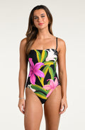 Woman wearing a floral one-piece swimsuit on a white background
