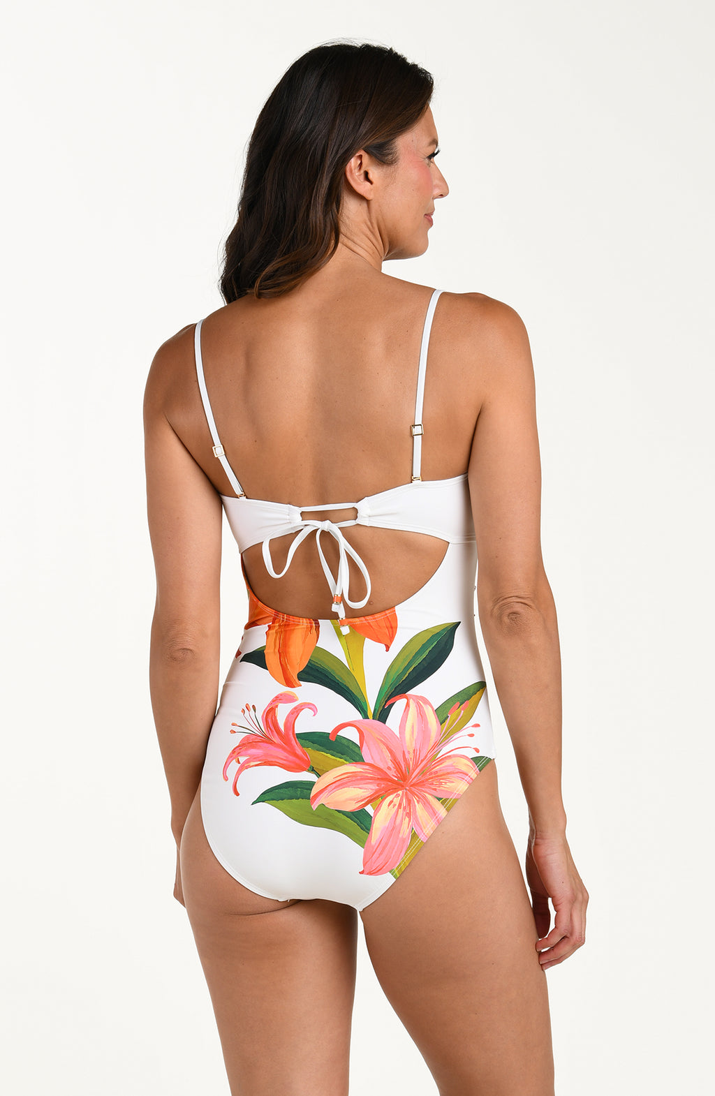 Woman wearing a floral one piece bandeau swimsuit on a white background