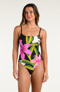 Woman wearing a floral one-piece swimsuit on a white background