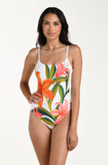 Woman wearing a floral one-piece swimsuit on a white background