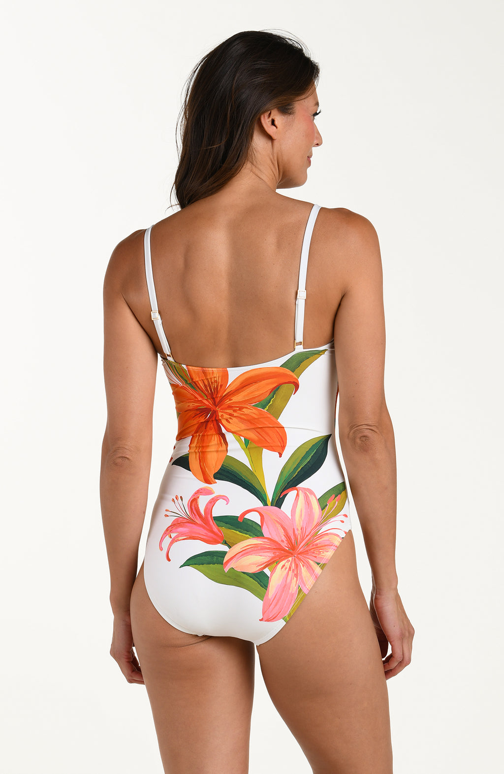 Woman wearing a floral one piece swimsuit on a white background