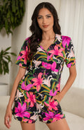 Woman wearing bright floral colored t-shirt and short pajama set. 
