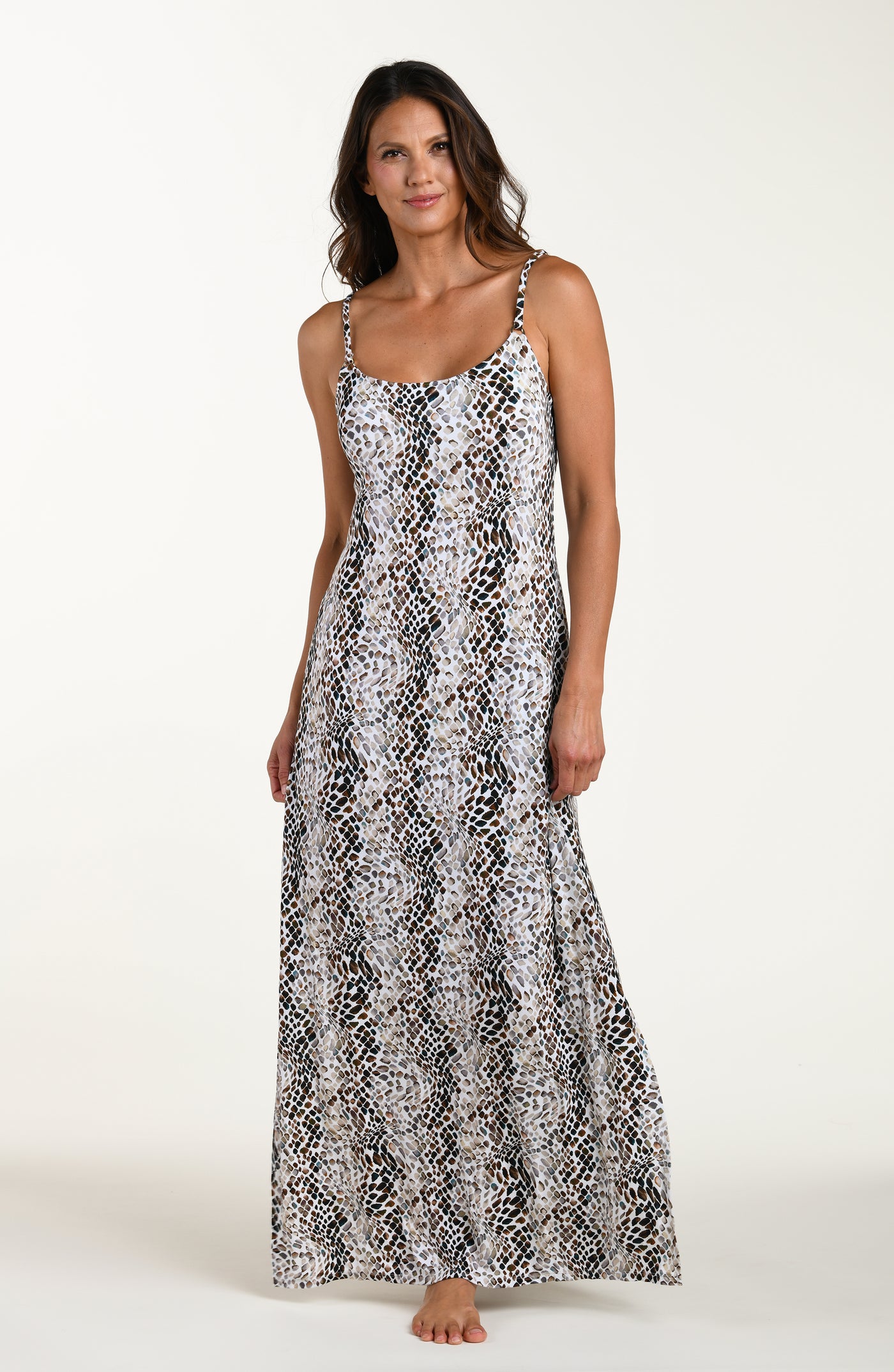 
                  
                    Full body front image of model wearing a sleeveless maxi cover-up dress with thin over the shoulder straps, pockets, and an allover taupe colored animal print.
                  
                