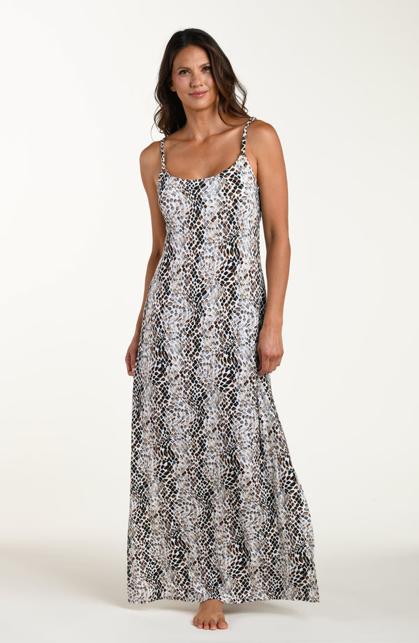 Full body front image of model wearing a sleeveless maxi cover-up dress with thin over the shoulder straps, pockets, and an allover taupe colored animal print.
