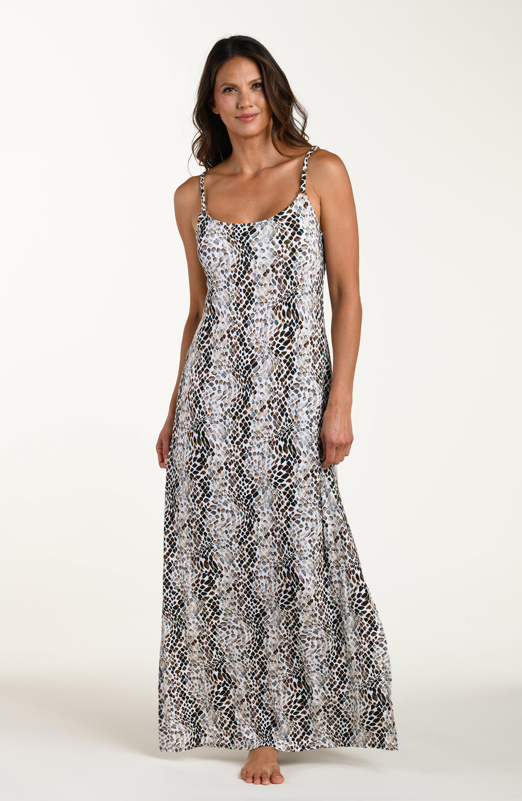 Full body front image of model wearing a sleeveless maxi cover-up dress with thin over the shoulder straps, pockets, and an allover taupe colored animal print.