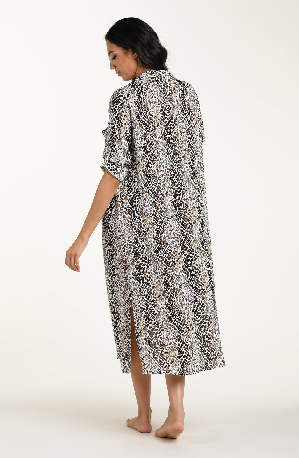 Full body back image of model wearing a midi-length cover-up dress featuring a taupe colored animal print with three-quarter sleeves, a V-neckline, and a waist tie belt.