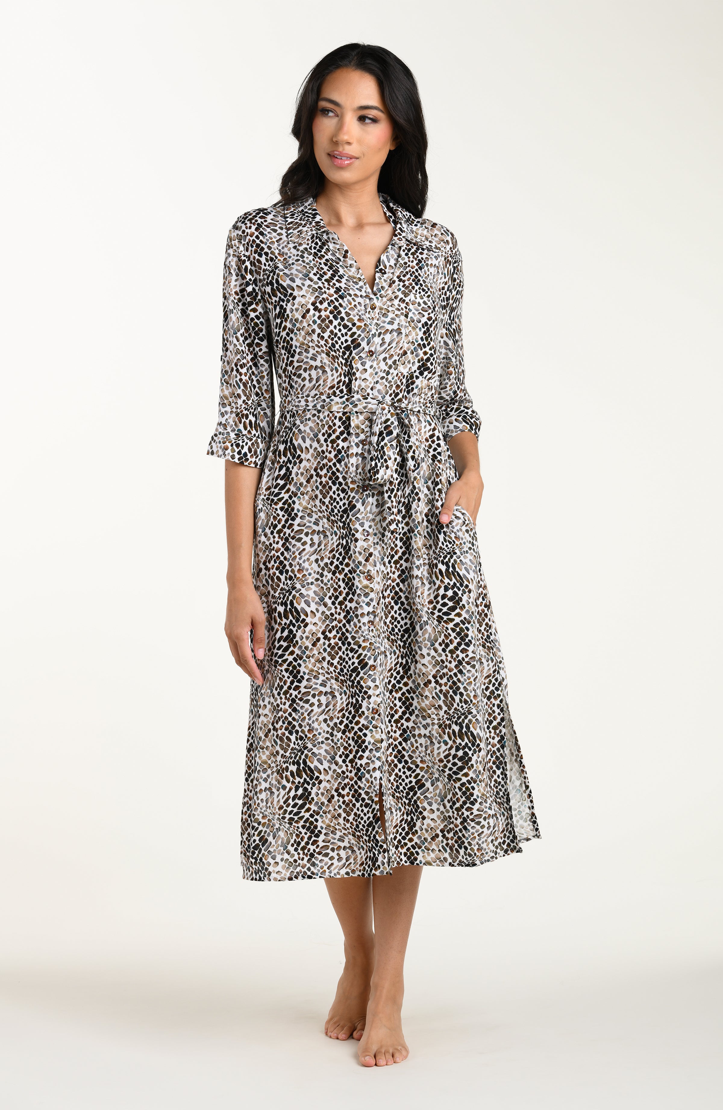 Full body front image of model wearing a midi-length cover-up dress featuring a taupe colored animal print with three-quarter sleeves, a V-neckline, and a waist tie belt.