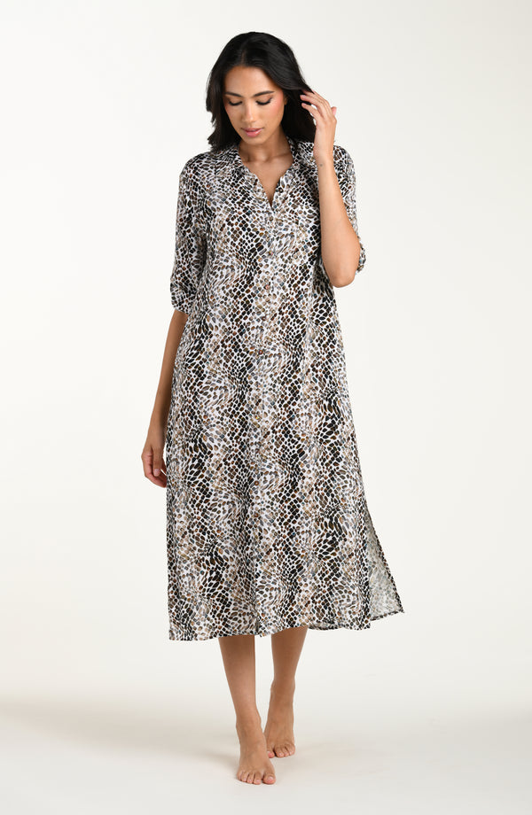 Full body front image of model wearing a midi-length cover-up dress featuring a taupe colored animal print with three-quarter sleeves, a V-neckline, and a waist tie belt.