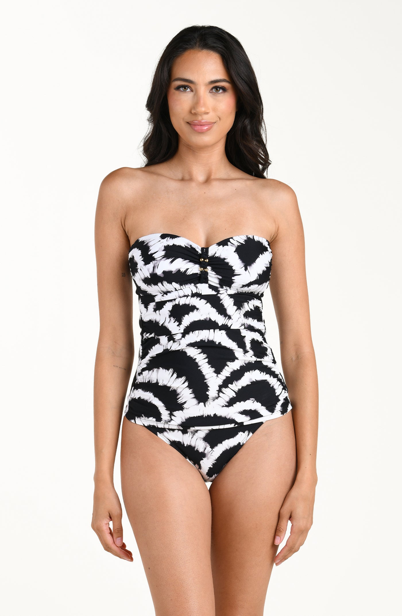 
                  
                    Front image of model wearing a black and white multicolored tankini top featuring a supportive, body-hugging fit with removable straps and gentle ruching for a flattering, comfortable silhouette. This is paired with a matching bikini bottom. 
                  
                