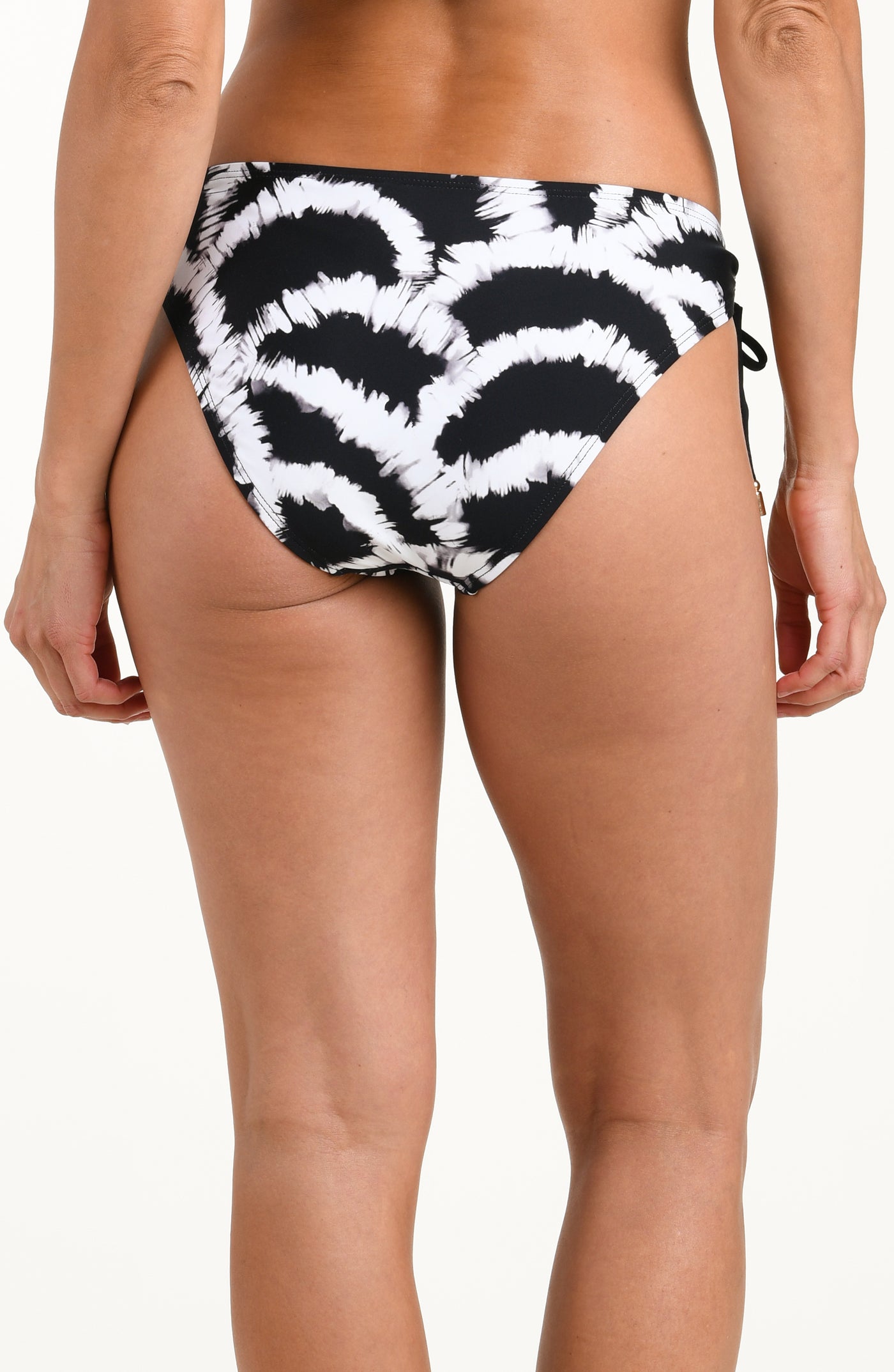 
                  
                    Back image of model wearing a black and white multicolored bikini bottom featuring adjustable side ties and moderate rear coverage. 
                  
                