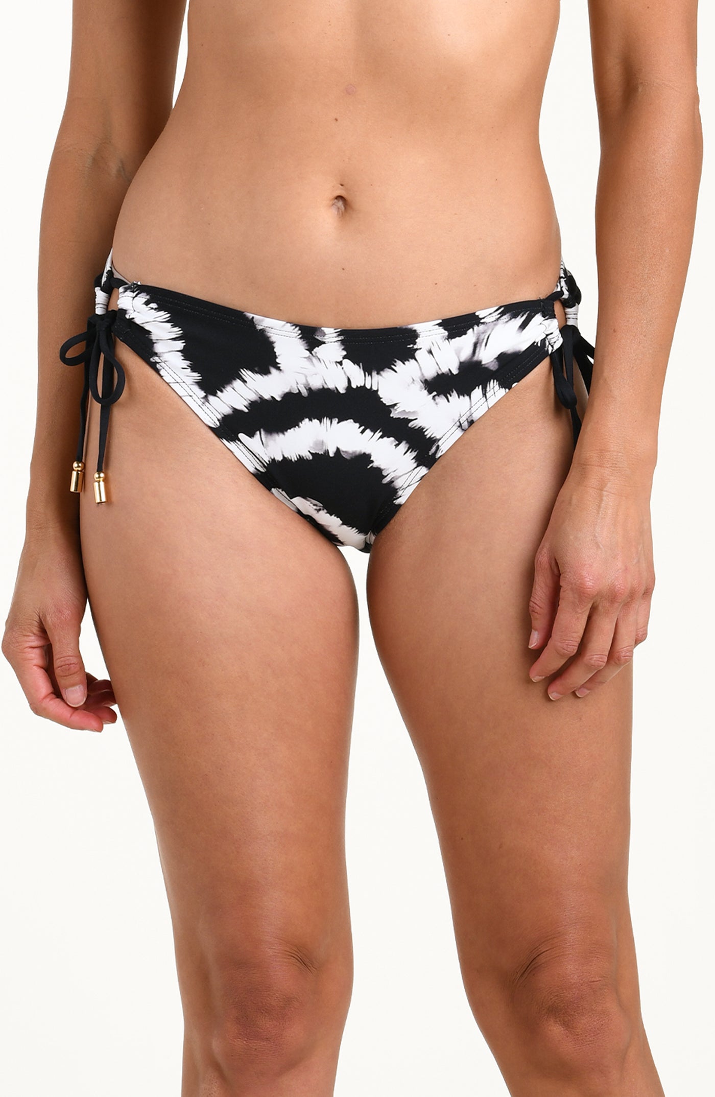 
                  
                    Front image of model wearing a black and white multicolored bikini bottom featuring adjustable side ties and moderate coverage. 
                  
                