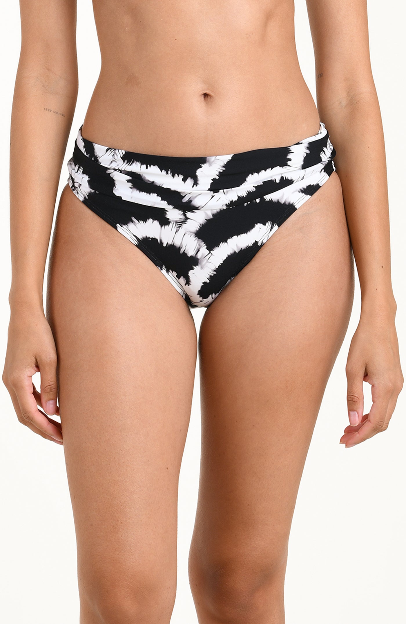 
                  
                    Front image of model wearing a black and white multicolored bikini bottom featuring a mid-rise fit with a fold-over waistband. 
                  
                
