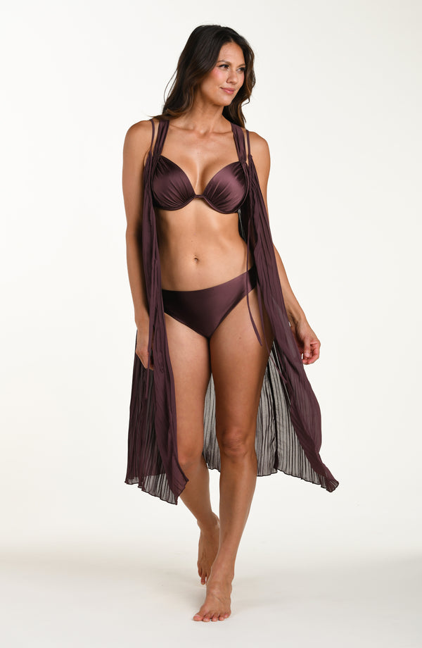 Woman wearing a burgundy bikini with a matching cover-up on a white background