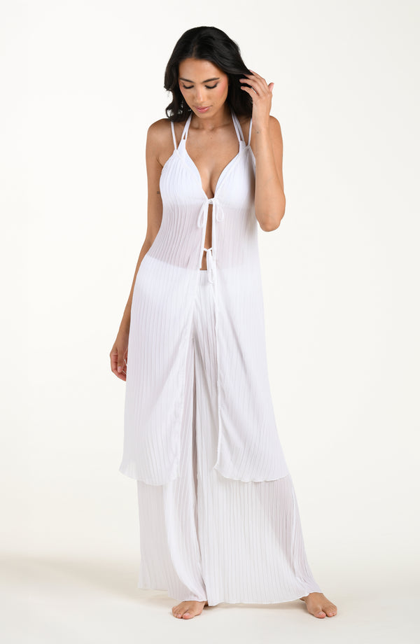 Woman wearing a white dress with a plain background