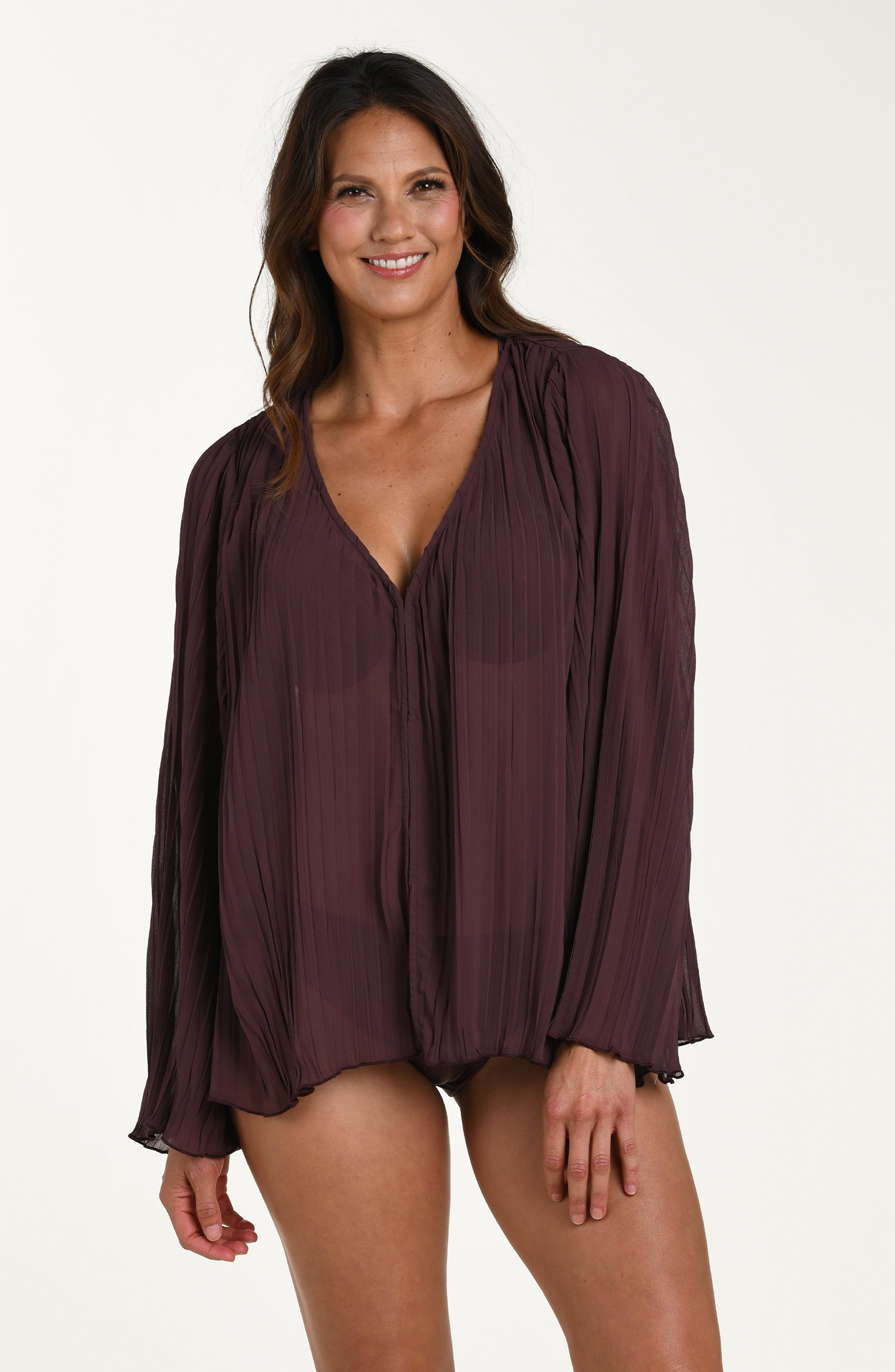 Woman wearing a purple long-sleeve top on a white background