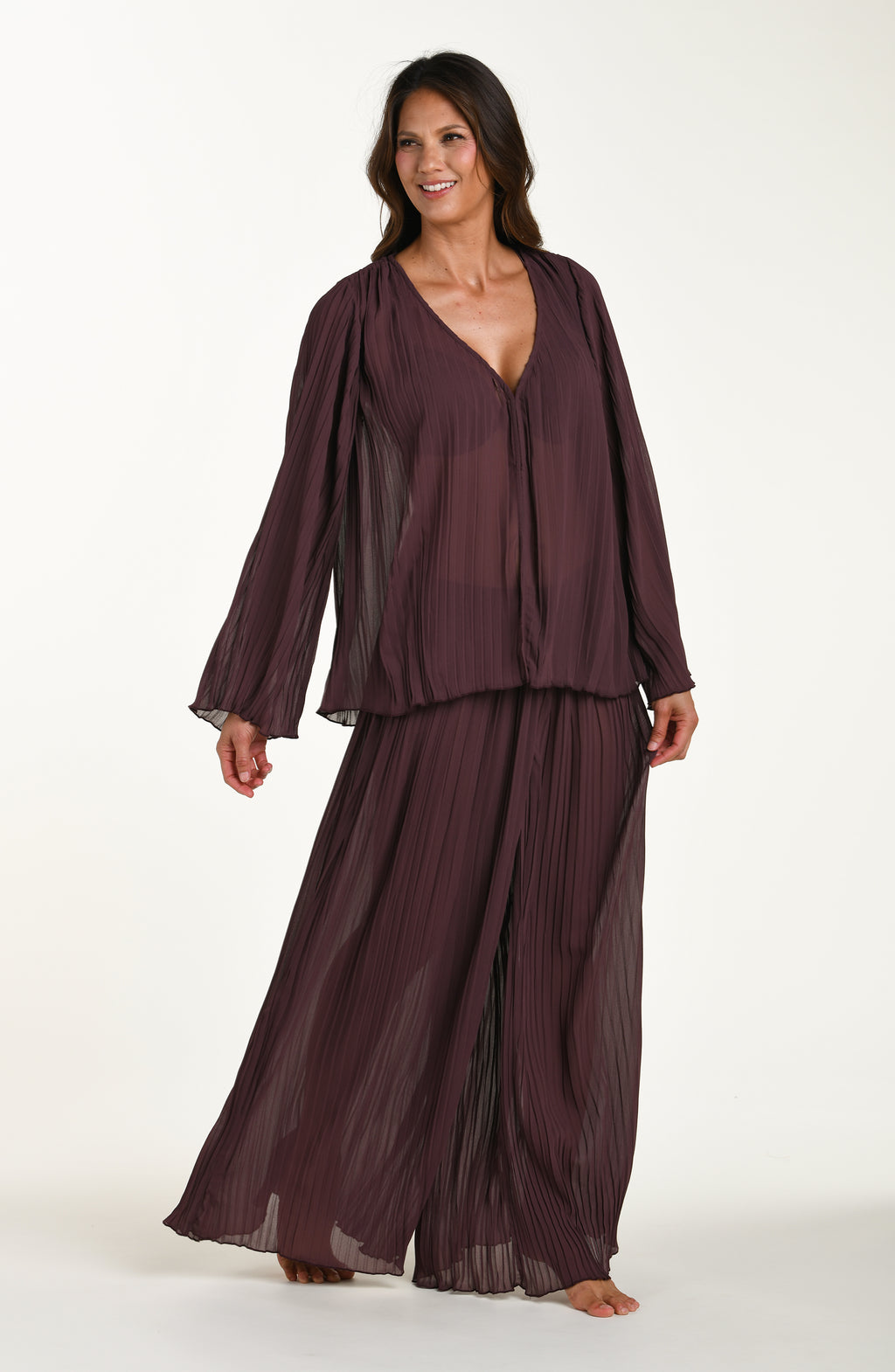 Woman wearing a dark brown outfit on a white background