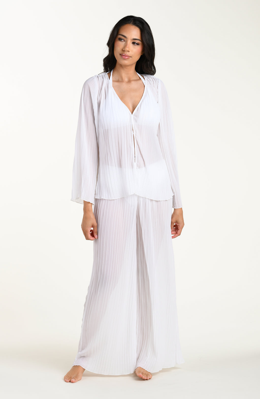 Woman wearing a white outfit on a white background