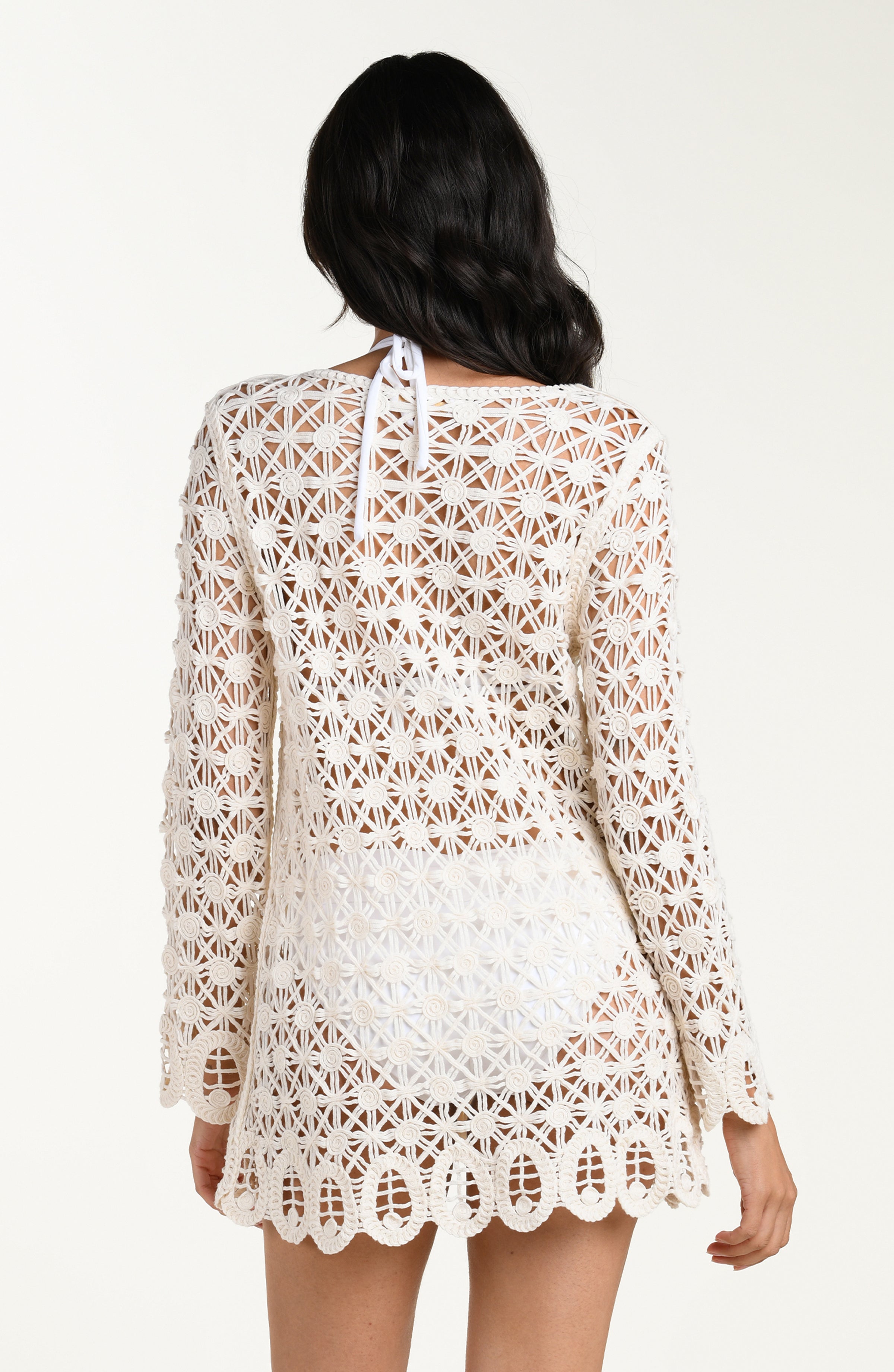 White lace dress worn by a person on a white background