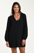 Front image of model wearing a black long-sleeve tunic cover-up with a V-neckline and sheer lace trim accents. 
