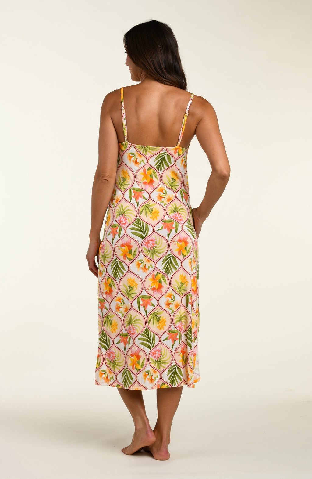 Woman wearing a floral cover up dress on a white background