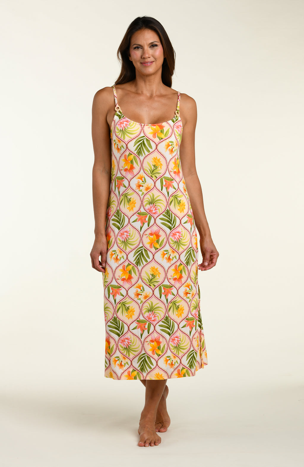 Woman wearing a floral cover up dress on a white background