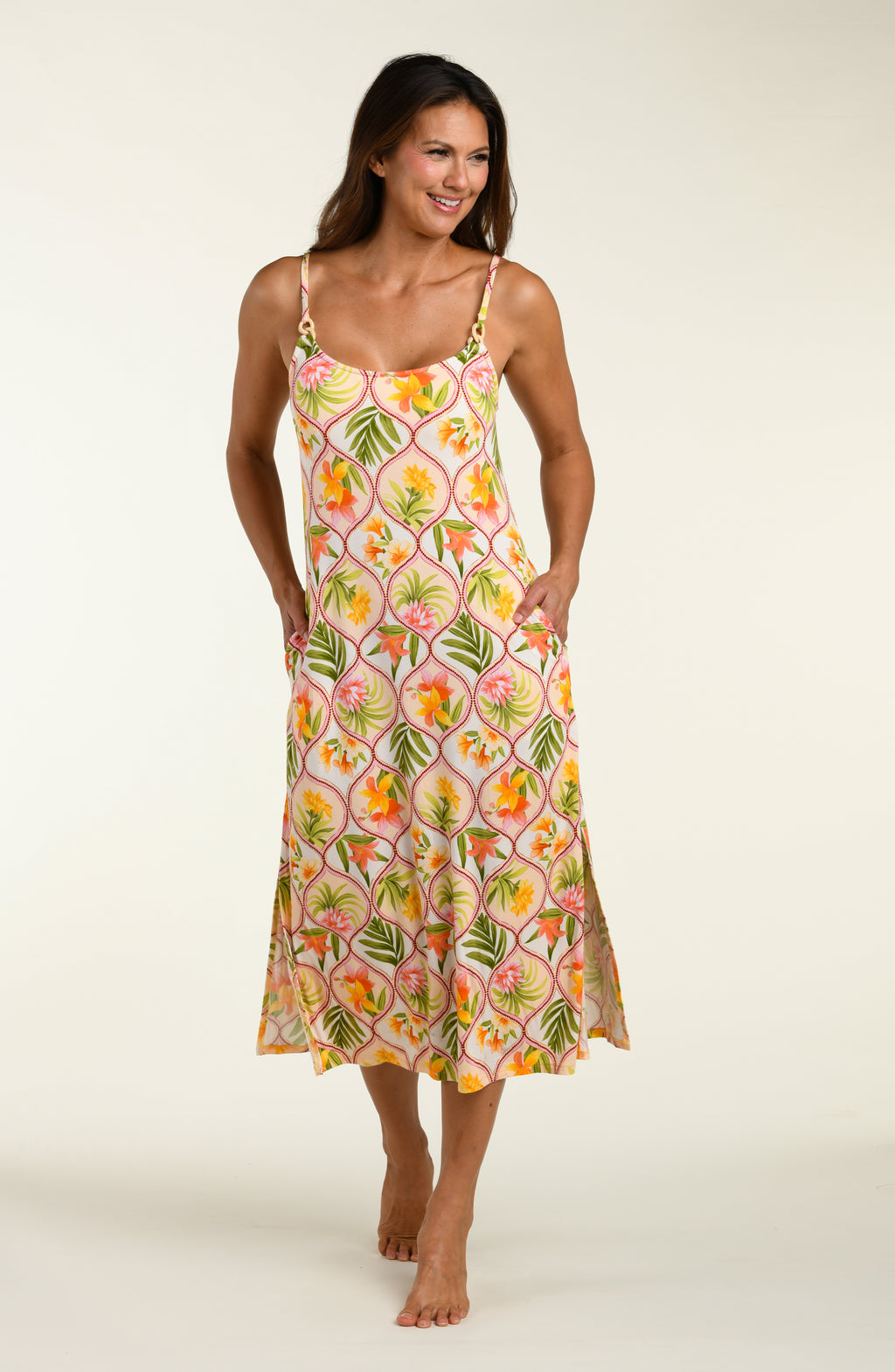 Woman wearing a floral cover up dress on a white background
