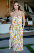 Woman wearing a floral maxi cover up dress in an outdoor setting