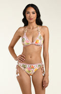 Woman wearing a floral bikini top and matching bikini bottom on a plain background