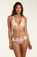 Woman wearing a floral bikini top and matching bikini bottom on a beige background