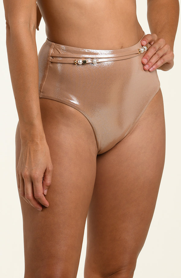 Beige high-waisted bikini bottom with metallic waistband on a beige background