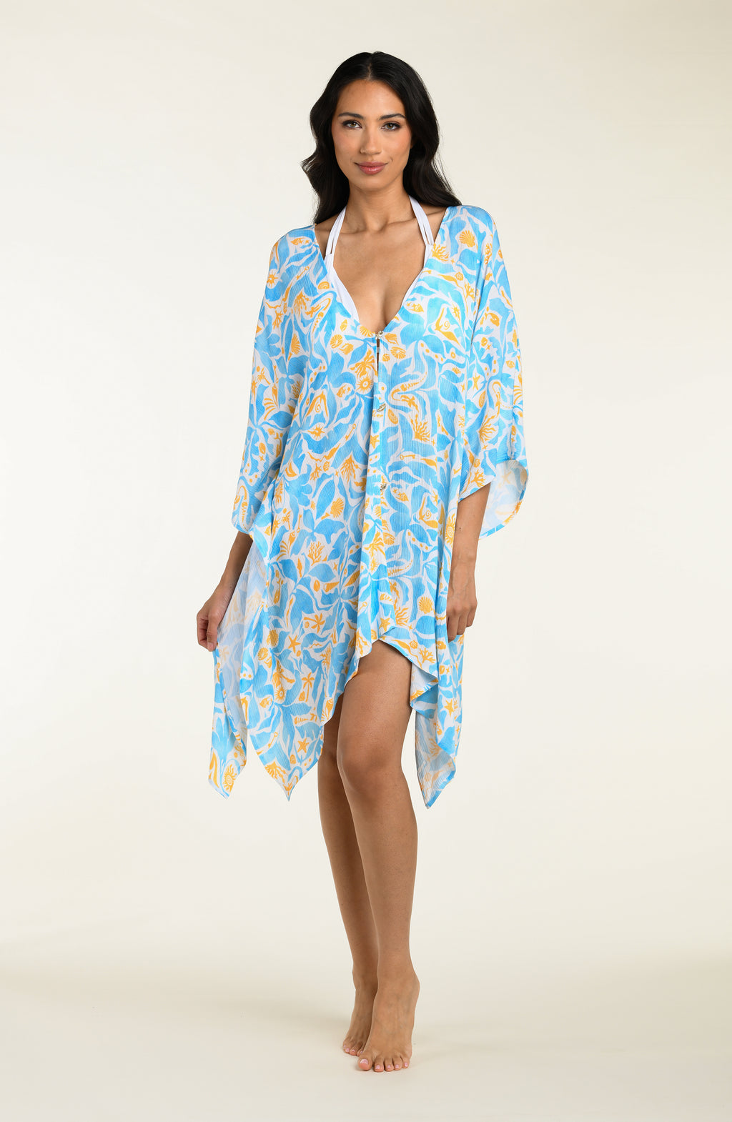 Woman wearing a blue floral kimono cover-up on a white background