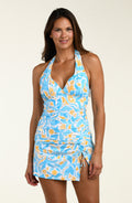 Woman wearing a blue and yellow patterned tankini top and matching swim skirt against a white background. 