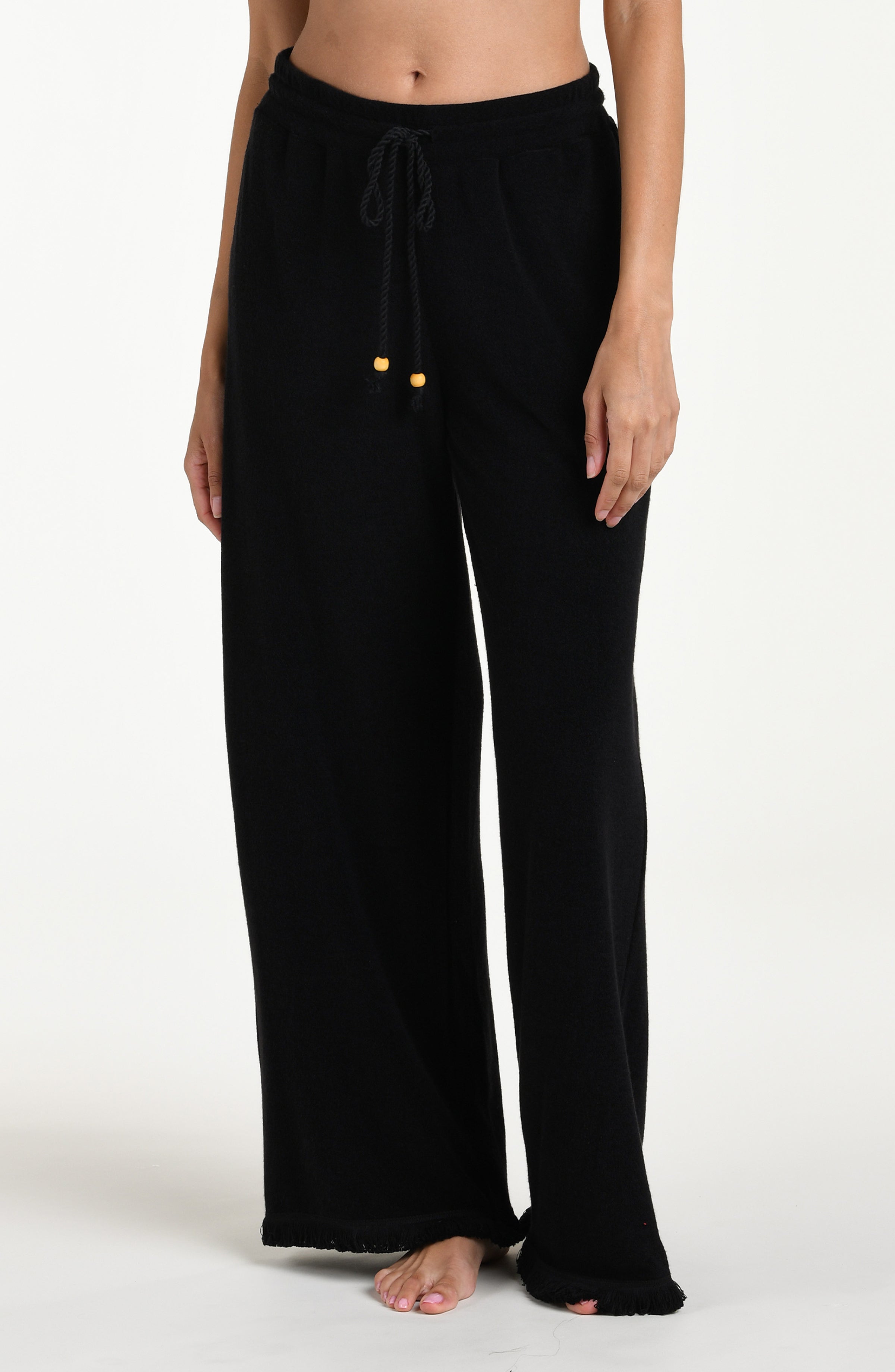 Black wide-leg beach pants with drawstring waist against a white background