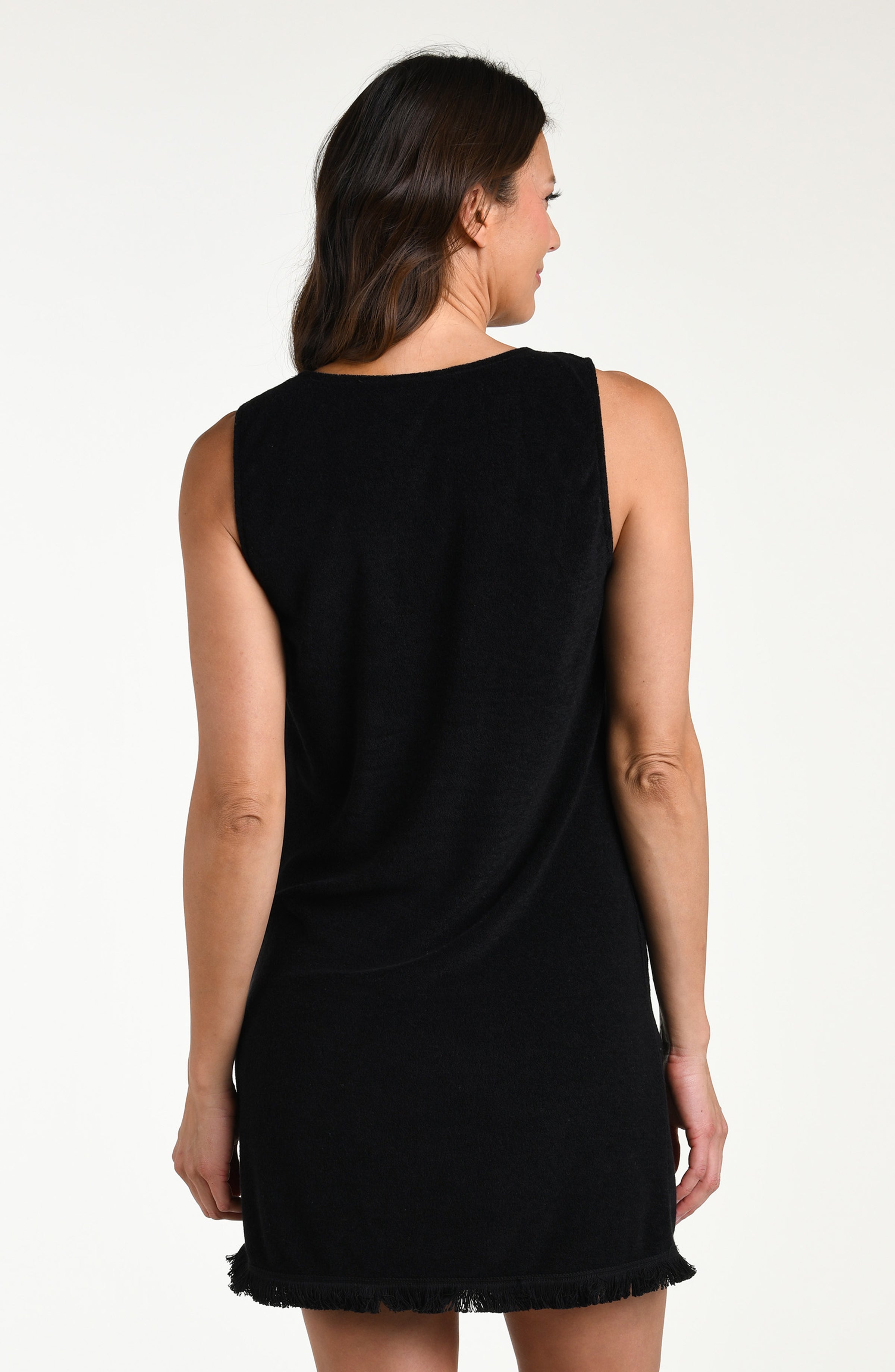 Woman wearing a black mini cover up dress against a white background