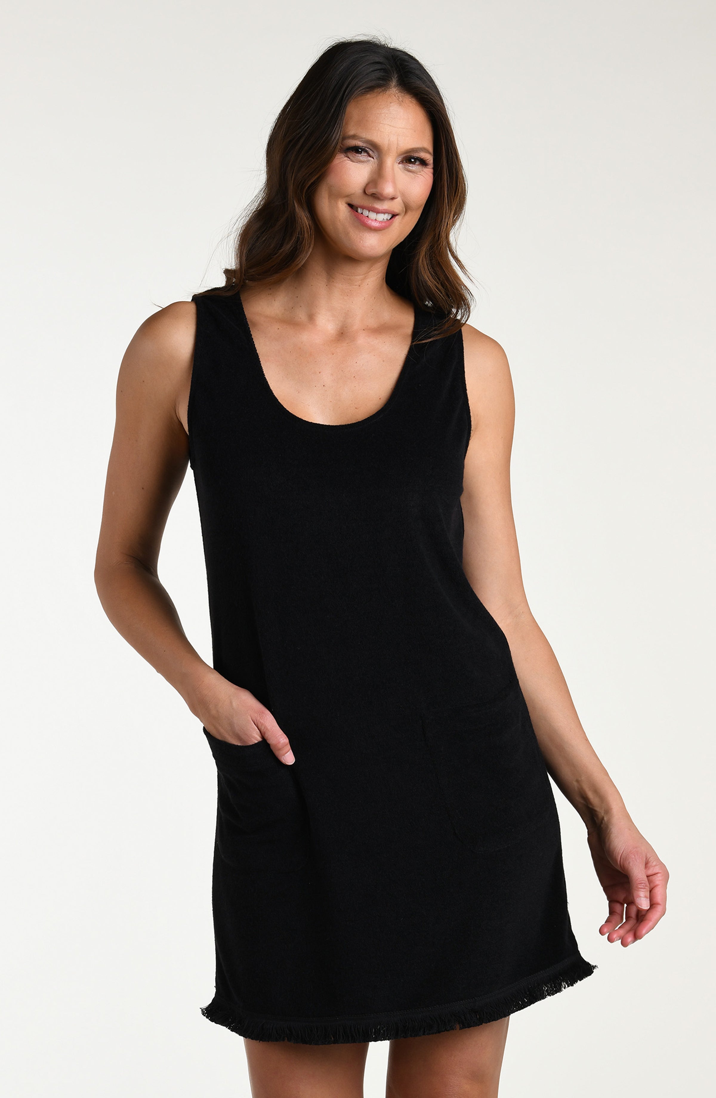Woman wearing a black mini cover up dress against a white background