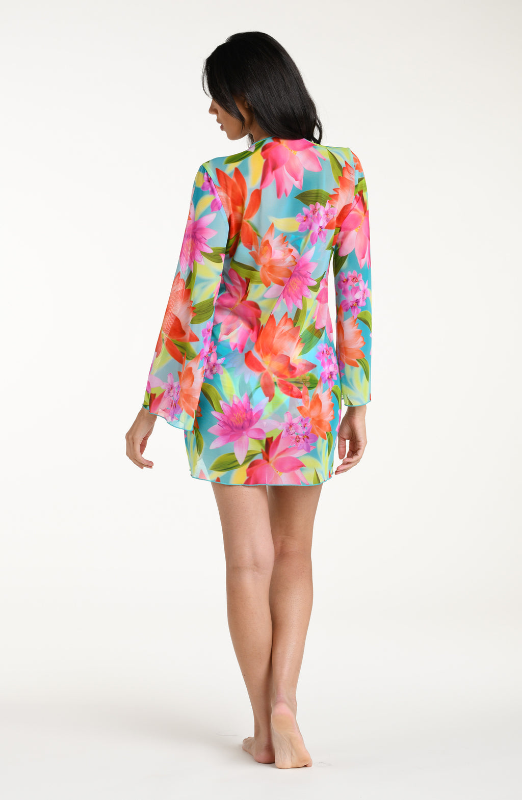 Woman wearing a bright floral kimono cover up with a matching bikini underneath, against a white background.