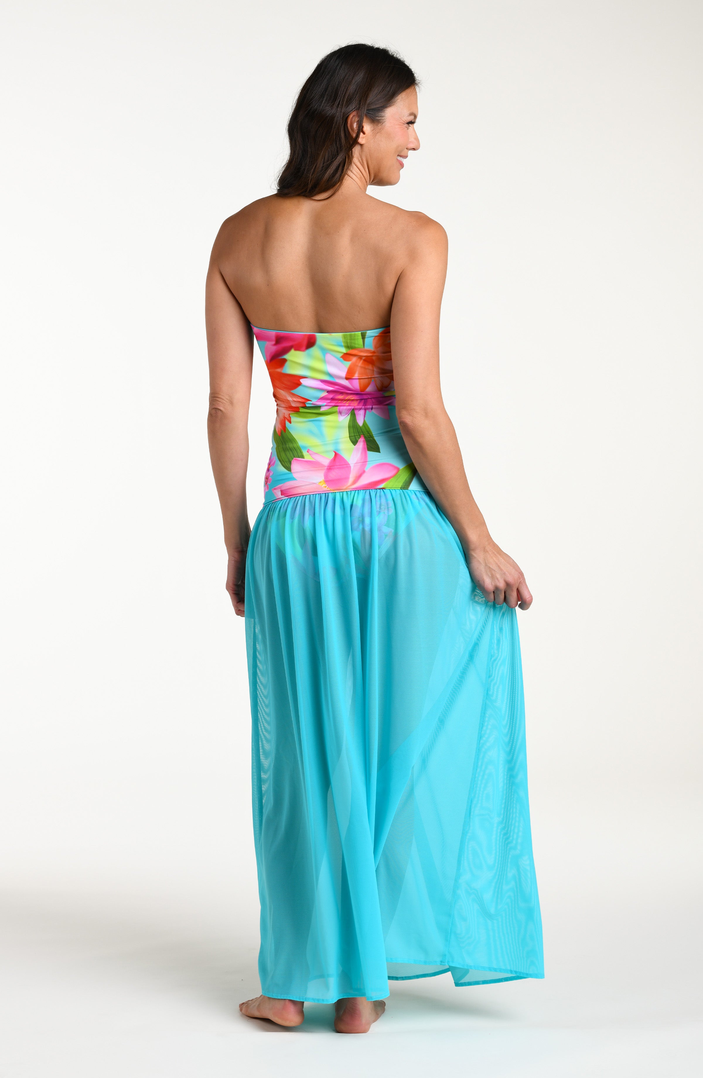 Woman wearing a turquoise convertible maxi dress cover up against a white background